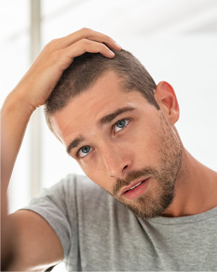 young-man-checking-hair-in-mirror-2025-01-07-12-12-18-utc (2)